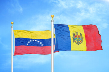 Venezuela and Moldova two flags on flagpoles and blue sky