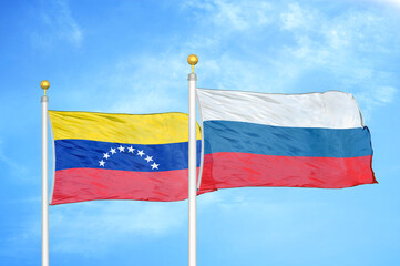 Fototapeta na wymiar Venezuela and Russia two flags on flagpoles and blue sky