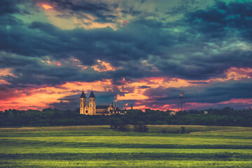 Fototapeta premium Victoria, KS USA - Panorama View of the Midwest Wheat Field Prairie and Cathedral of the Plains in Victoria Kansas USA Prairie in Sunset Sky Clouds