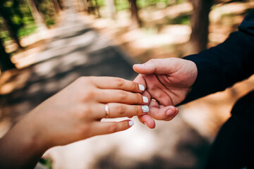 Close-up of a woman and a man holding out their hands, two people holding hands. The symbol is a sign of sincere feelings, a loved one. the concept of true friendship, outdoors