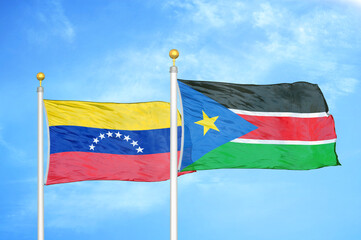Venezuela and South Sudan two flags on flagpoles and blue sky