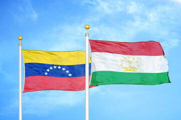 Fototapeta na wymiar Venezuela and Tajikistan two flags on flagpoles and blue sky