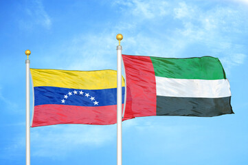 Venezuela and United Arab Emirates two flags on flagpoles and blue sky