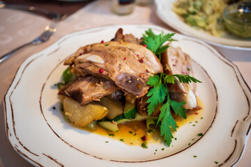 Sliced pork ribs on a plate with vegetables