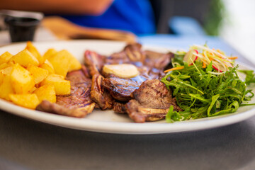 Beef Ribs on plate with potato and vegetables