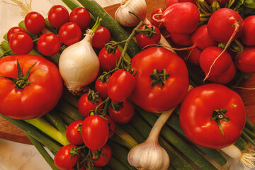 fresh tomatoe onion garlic radish and leek on table