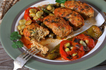 Fish meatballs in tomato sauce. Meatballs with a side dish of green beans and vegetables in tomato sauce 
close-up in a plate on the table. horizontal
