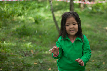 Girl 4 years old in the forest. Little girl of Asian appearance