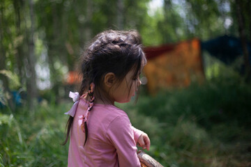 Girl 4 years old in the forest. Little girl of Asian appearance