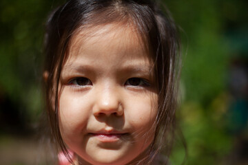 Girl 4 years old in the forest. Little girl of Asian appearance