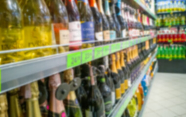 Alcohol showcase blurred background. Blurred abstract background of shelf in supermarket