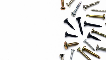 Different types of metal screws on a white background, copy space and top view                   