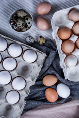 Quail eggs with native or healthy eggs are outside or inside the container.