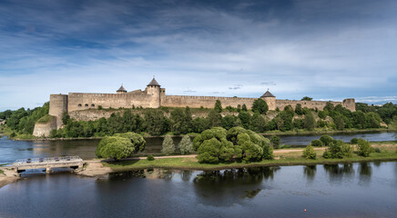 Fototapeta na wymiar Narva, on the Narva river, at the eastern extreme point of Estonia, at the Russian border. The Narva Castle towers over the Estonian side, while Ivangorod Fortress sprawls across the Russian bank.