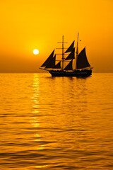 Fototapeta na wymiar sailing ship in the sunset