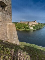Fototapeta na wymiar Narva, on the Narva river, at the eastern extreme point of Estonia, at the Russian border. The Narva Castle towers over the Estonian side, while Ivangorod Fortress sprawls across the Russian bank.