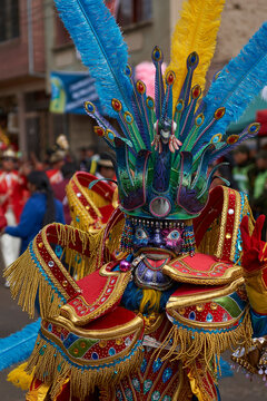Masked morenada dancer in ornate costumes parade through the mining city of Oruro on the Altiplano of Bolivia during the annual carnival.