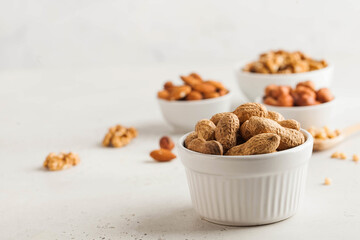 Peanuts in their shells. Assorted nuts almonds, hazelnuts, walnuts. Healthy snacks. Copy space.