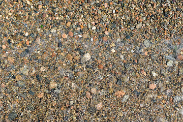 Top view pebbles on the edge of the lake.
