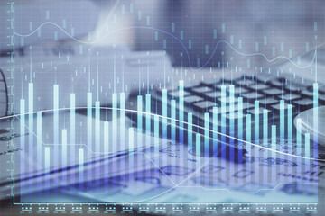 Double exposure of financial chart drawings and desk with open notebook background. Concept of forex market