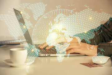 Multi exposure of woman hands typing on computer and business theme hologram drawing. Success concept.