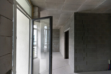 Small apartment without repair in a new building. A room in an unfinished house. Walls of foam block and concrete floor in a tiny apartment.