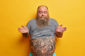 I dont care about rules. Indifferent careless questioned bearded man shrugs shouldres with...