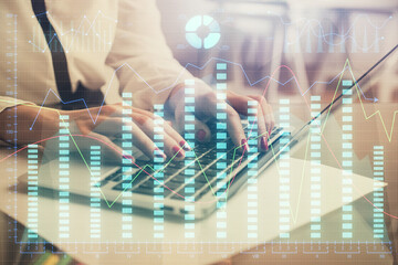 Fototapeta premium Multi exposure of woman hands typing on computer and financial graph hologram drawing. Stock market analysis concept.