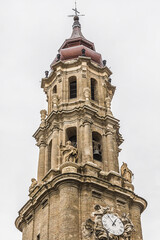 Fototapeta na wymiar Bell tower of Savior Cathedral (Catedral del Salvador or Cathedral La Seo, 1683) - Roman Catholic cathedral in Zaragoza, Spain. Cathedral is part of World Heritage Site Mudуjar Architecture of Aragon.