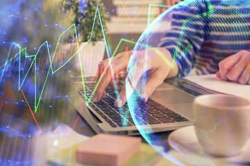 Double exposure of woman hands typing on computer and forex chart hologram drawing. Stock market invest concept.