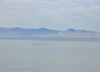 Smoke from a factor in Northern Salt Lake can be seen in the distance across the Great Salt Lake from Antelope Island, Utah