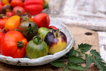 Multicolored tomatoes on a chalkboard top view, selective focus.