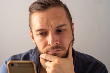 Portrait of  Young Blond Hair Caucasian Male Looking at the Phone