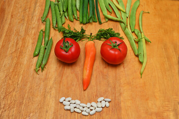 face made from vegetables on wooden  table 