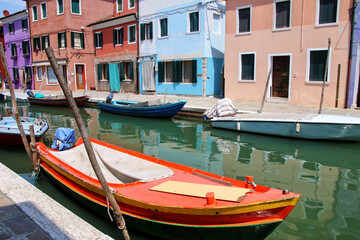 Fototapeta na wymiar Boat anchored in canal in Burano, Venice, Italy