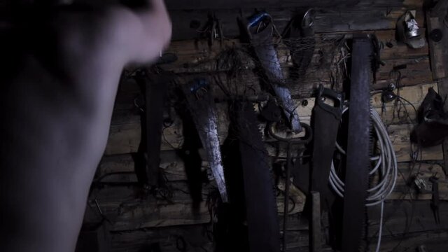 Mad scary caucasian man maniac chopping with an ax in an old abandoned house, copy space