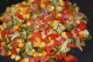 Vegetable Salad saute in Pan with Tomato Brocolli capsicum ready to be prepared for Khow Suey