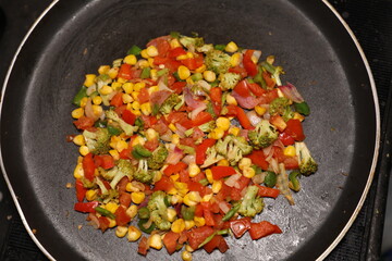 Vegetable Salad saute in Pan with Tomato Brocolli capsicum ready to be prepared for Khow Suey