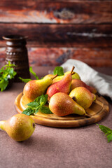 Ripe and juicy pears on wooden tray in rustic style