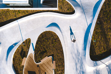 Aerial view of roller skater striking a shadow pose in city square in Kaunas