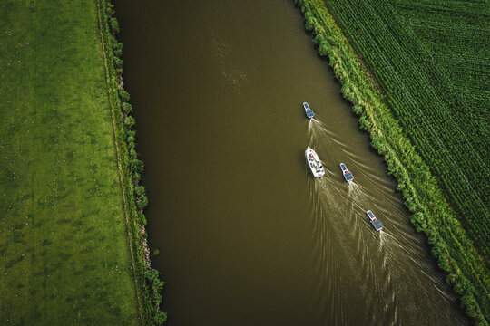 Aerial view of solar panel boats navigating through the farmlands of Harlingen, Friesland, The Netherlands.
