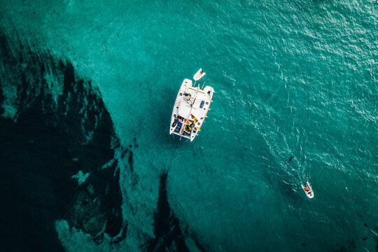 Aerial view of a catamaran anchored and a digny at Lavezzu Island, Corsica, France.