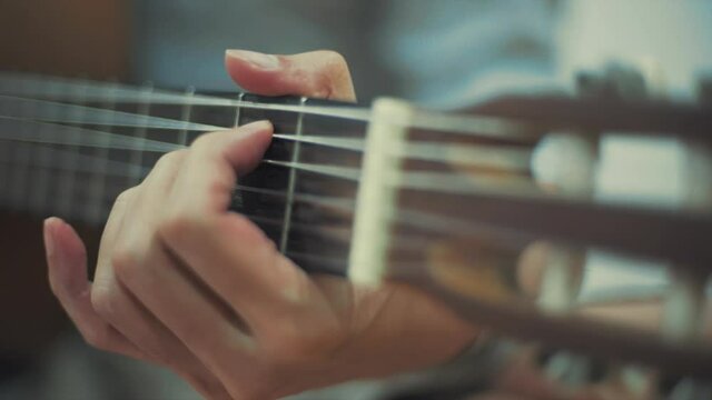 Close-up hand Playing guitar
.
Close up male fingers of guitarist strumming the strings.