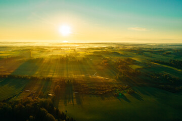 Green and Yellow agriculture field from above captured with a drone during sunset