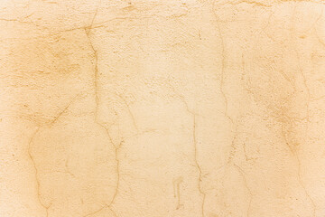 Beige concrete wall with cracks. Backgrounds and textures. Close-up. Space for text.
