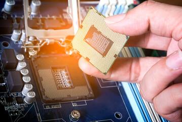 Hand of computer engineering brings computer cpu processor memory change components into socket...