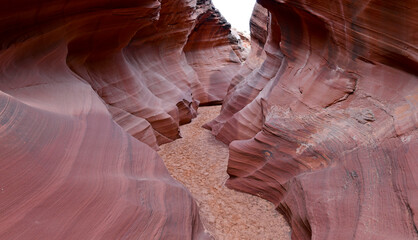 Slot Canyons, commonly found in arid areas such as Utah, Arizona and southwest USA are formed by water erosion typically in sandstone and are at risk of flash flooding