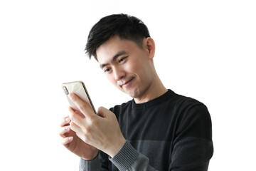The handsome Asian man is amazed with the phone and he looks at the mobile phone to read the good news in the message. The young Asian man is surprised by the mobile app.  on a white background