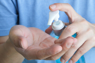A man cleans his hands with alcohol gel to protect against coronavirus covid-19.