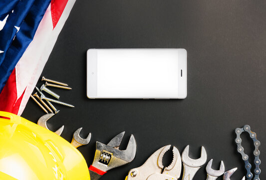 USA Labor day concept, different kinds wrenches, American flag and smartphone blank screen on dark green. First Monday in September, creation labor movement and dedicated to social of American worker - Powered by Adobe